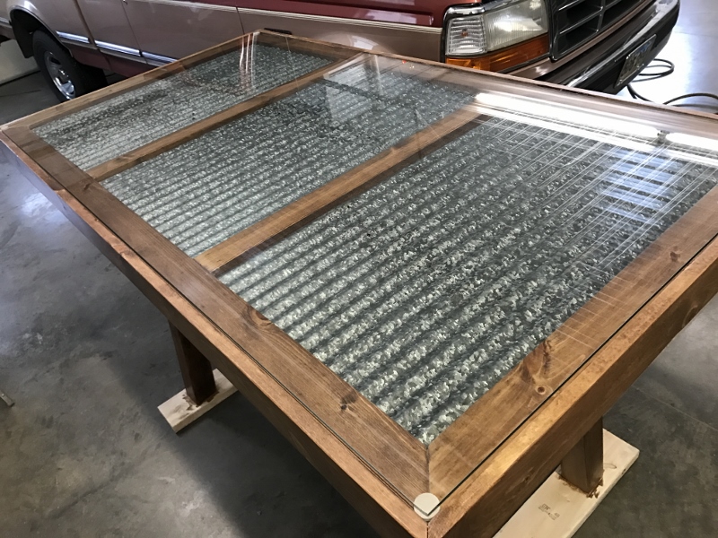 One of a kind bar height (42") table. Glass top with vintage Strongbarn tin inserts. 